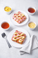 Cheese corn sausages baked sandwich in a plate