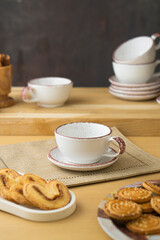 Ceramic teacup and saucer set on kitchen table
