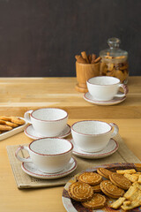 Ceramic teacup and saucer set on kitchen table