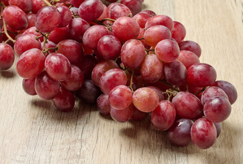 A bunch of red ripe grapes on the table