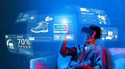 African teenager with VR glass looking at screen display discount. Person sitting at sofa while wearing augmented reality headset while connecting online shopping and choosing product. Ingenuity.