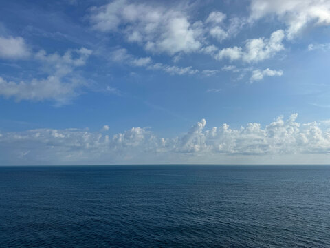 Calm blue sea and cloudy sky horizon
