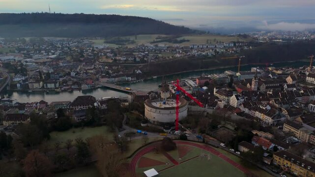 Panorama of Schaffhausen, Switzerland, showcasing historic city center, Emmersberg hill, and Rhinebruecke Schaffhausen-Feuerthalen. Misty morning light enhances beauty of this Swiss heritage site. 