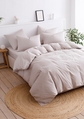 Bedroom with a double bed, fluffy down comforter and four pillows. Top view vertical photo