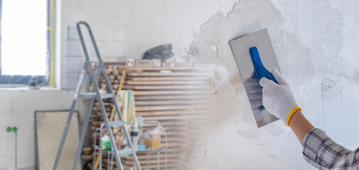 Puttying walls during repairs.