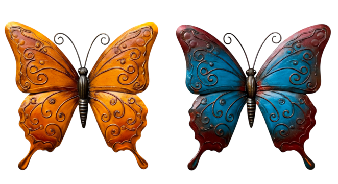 Set of two ornate metal butterfly wall decorations with swirling embossed patterns in vibrant orange and blue tones on a white background