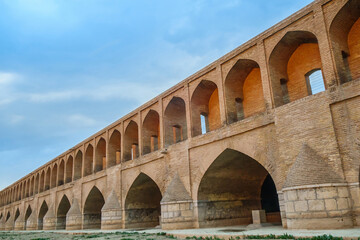 Fototapeta premium View of the Si-o-se-pol Bridge or Allahverdi Khan Bridge before sunset, Isfahan, Iran. The bridge was built in 1602. Nowadays, it is a popular tourist attraction in the city