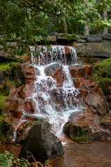 Waterfall in the park in summer. Keeley Falls in Andrew Haydon Park in Ottawa, Canada.