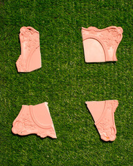 Picture frame broken, parts scattered on the lawn, creative conceptual spring natural layout
