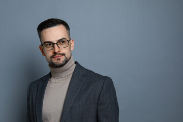 Portrait of handsome middle aged man on grey background, space for text