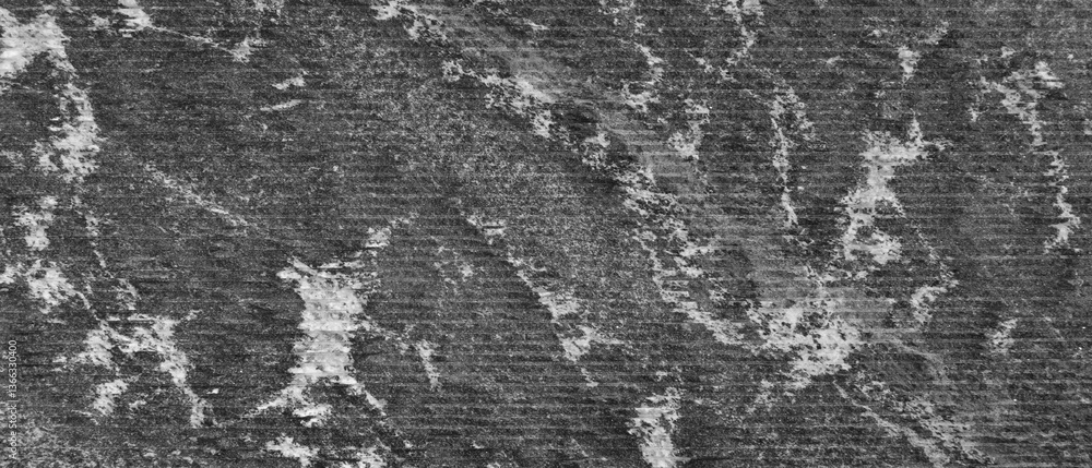 Fototapete Close up of black processed stone surface with lots of texture and pattern. Textured background has rough textured surface.