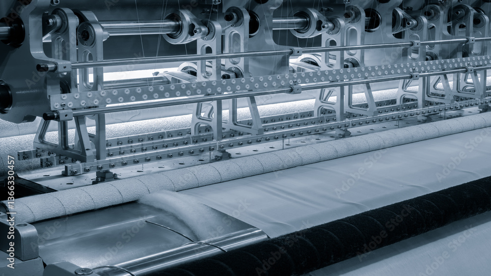 Aufkleber a machine is weaving a piece of fabric. the machine is made up of many parts, including a large meta