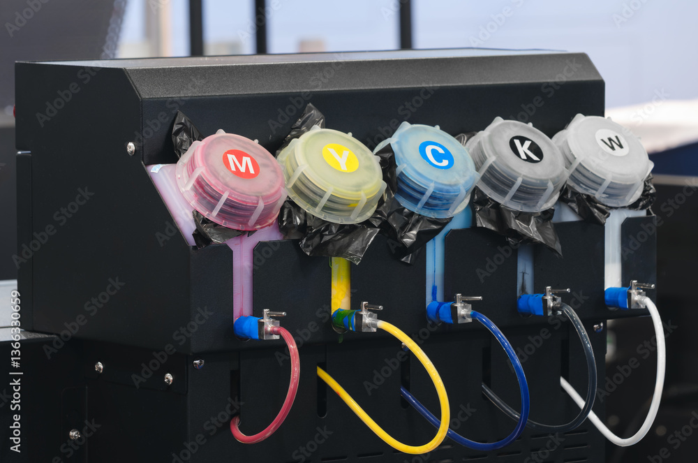 Poster a black box with five different colored ink cartridges. the cartridges are labeled with the letters 