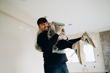  A man jokes while carrying his wife wrapped in a bag.