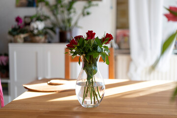 A bouquet of red roses in a glass vase. Greeting card concept