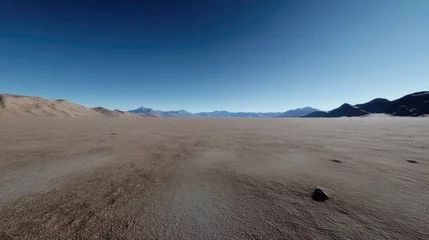 Selbstklebende Fototapeten Vast, sun-drenched desert landscape stretches to distant mountains under a clear blue sky.   © bambang