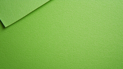 Fototapeta premium A close-up of textured green paper sheets, showcasing a vibrant color and fine surface detail, ideal for arts and crafts projects.