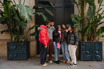 A multinational group of young people enjoying a fun day outdoors, laughing, smiling, and posing...