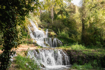 Beautiful waterfalls flowing through lush green vegetation during summer in Krka national park,...