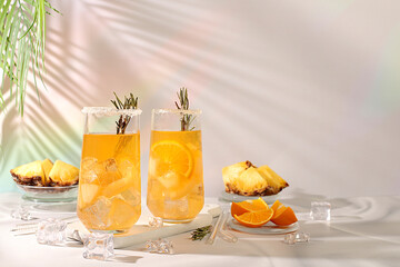 Summer party concept. Tequila, rum and vodka cocktail with pineapple slices, orange, ice and...