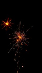 Intense fiery sparks burst against a stark black backdrop, element, ignition