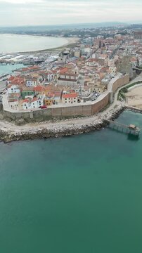 Aerial drone view of the historic town of Termoli, Italy, with coastline and old city walls