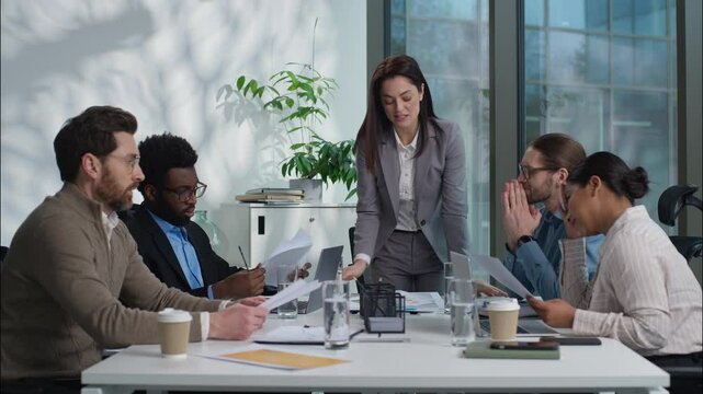 Caucasian woman leader arguing shout stress financial problem trouble documents bad work result boss angry talk dissatisfied team in office businesspeople business diversity multinational women men
