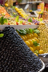 Colourful olives and fruit for sale in the souk bazaar in Meknes, Morocco. Photographed in the...