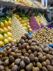 Colourful olives and fruit for sale in the souk bazaar in Meknes, Morocco. Photographed in the kissaria, covered market.