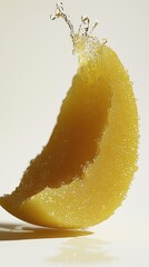 Mango slice splash. Water cascading off fruit. Beige background. Suitable for food advertising