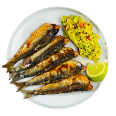 Carcasses of fried sardines served with spicy Mexican vegetable snack guacamole. Green puree is made from avocado and spicy spices. Isolated over white background