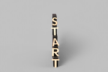 Word START with blocks on grey background