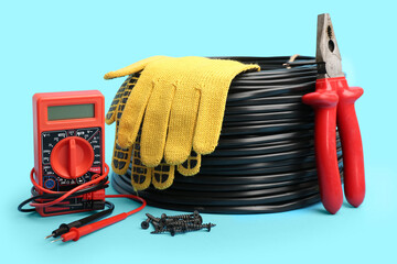 Set of different electrician's supplies on color background