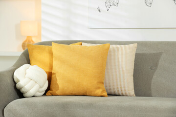 Soft decorative pillows on sofa in room