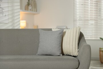 Soft decorative pillows on sofa in room