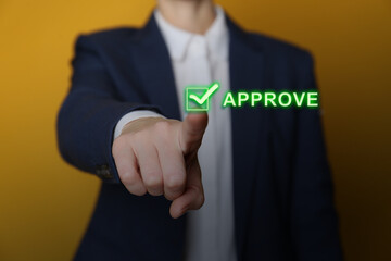 Business woman touching button Approve on virtual screen against orange background, closeup