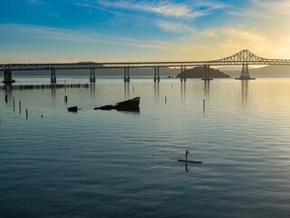 A woman paddleboards on the San Pablo bayRichmond, California, USA. She enjoys the calm water near...