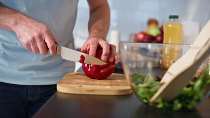 Chef hands slicing pepper wooden board kitchen closeup. Man chopping vegetables