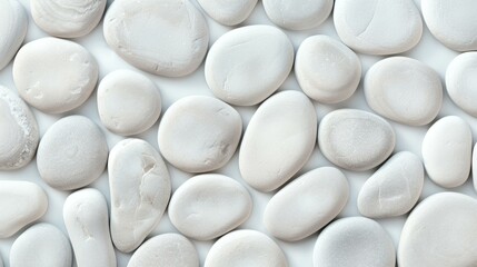 A serene banner background featuring a pattern of smooth white and gray seaside pebbles, perfect for calming designs.