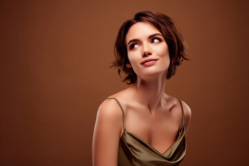 Naklejka premium Photo of pretty young girl look interesting empty space dressed stylish khaki outfit isolated on brown color background