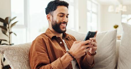 Online, smartphone and happy man relax in home for social media app, message response or reading ebook. Mobile, sofa and person on website for communication, chat notification or news on internet