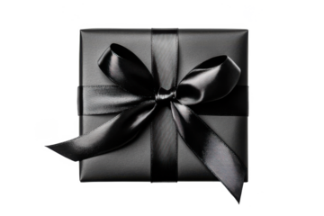 A black gift box tied with a shiny black ribbon set against a transparent background
