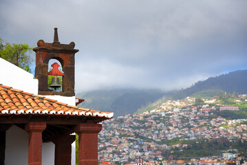 Bell tower against Funchal city