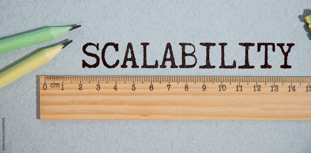 Poster notebook displaying the word scalability alongside a fan of cash, representing the importance