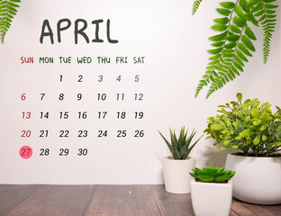 27 April calendar on wooden table with customizable. ideas or messages.