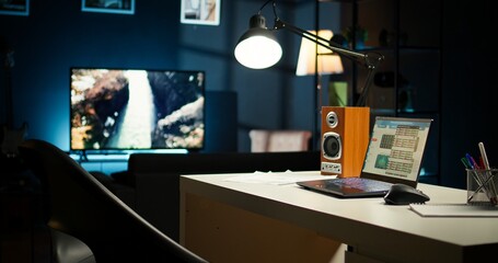 Cozy urban loft apartment with a contemporary home office setup. Wooden furniture, a TV and house plants highlighting the modern stylish interior design, blending comfort and creativity.