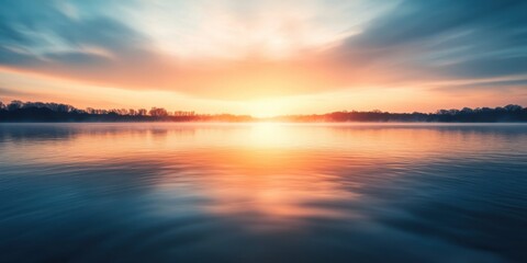 Obraz premium A peaceful sunrise over a tranquil lake with colorful reflections