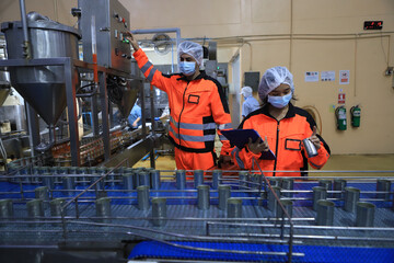 Food engineer working in the food factory for check production line