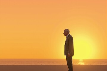 A Senior Male Silhouette Against a Vibrant Sunset at the Beach, Capturing Themes of Reflection, Solitude, and the Beauty of Nature