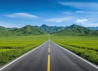 Fototapeta premium Driving on Empty Road Through Green Fields Towards Distant Mountains